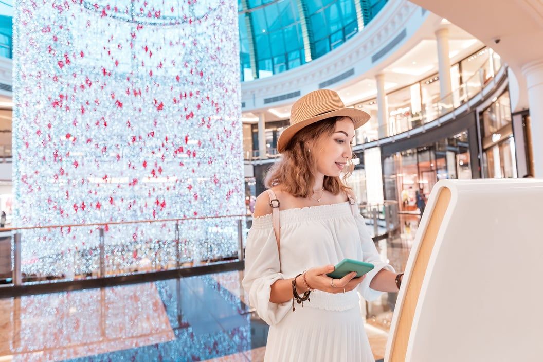 Customer using a self-service kiosk in a store