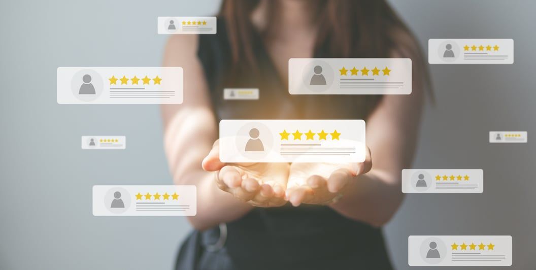 Hands holding a smartphone surrounded by floating five-star customer reviews