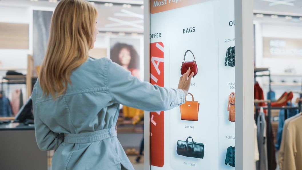 Customer using an interactive touch screen in a store