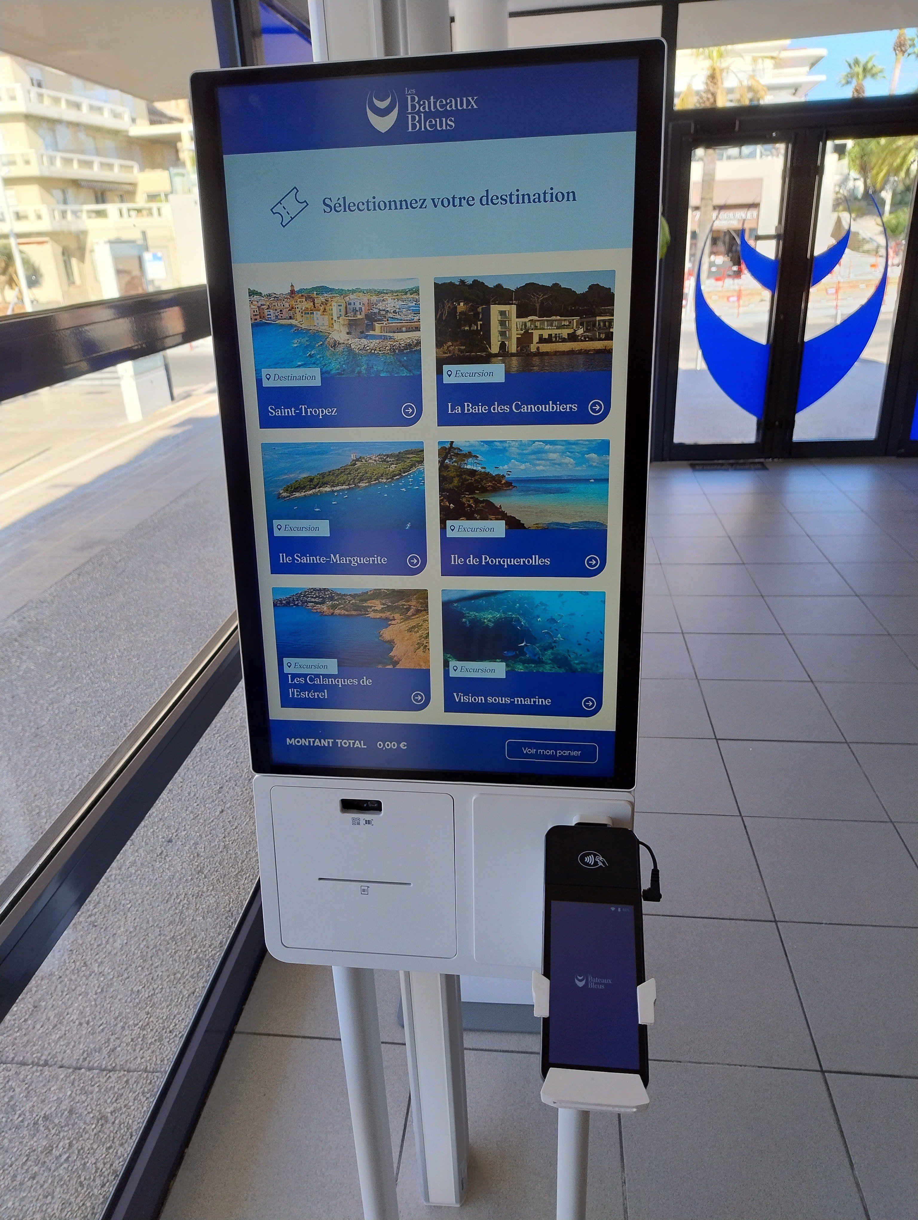 The outdoor interactive totem showing the available sea trips, with its payment terminal