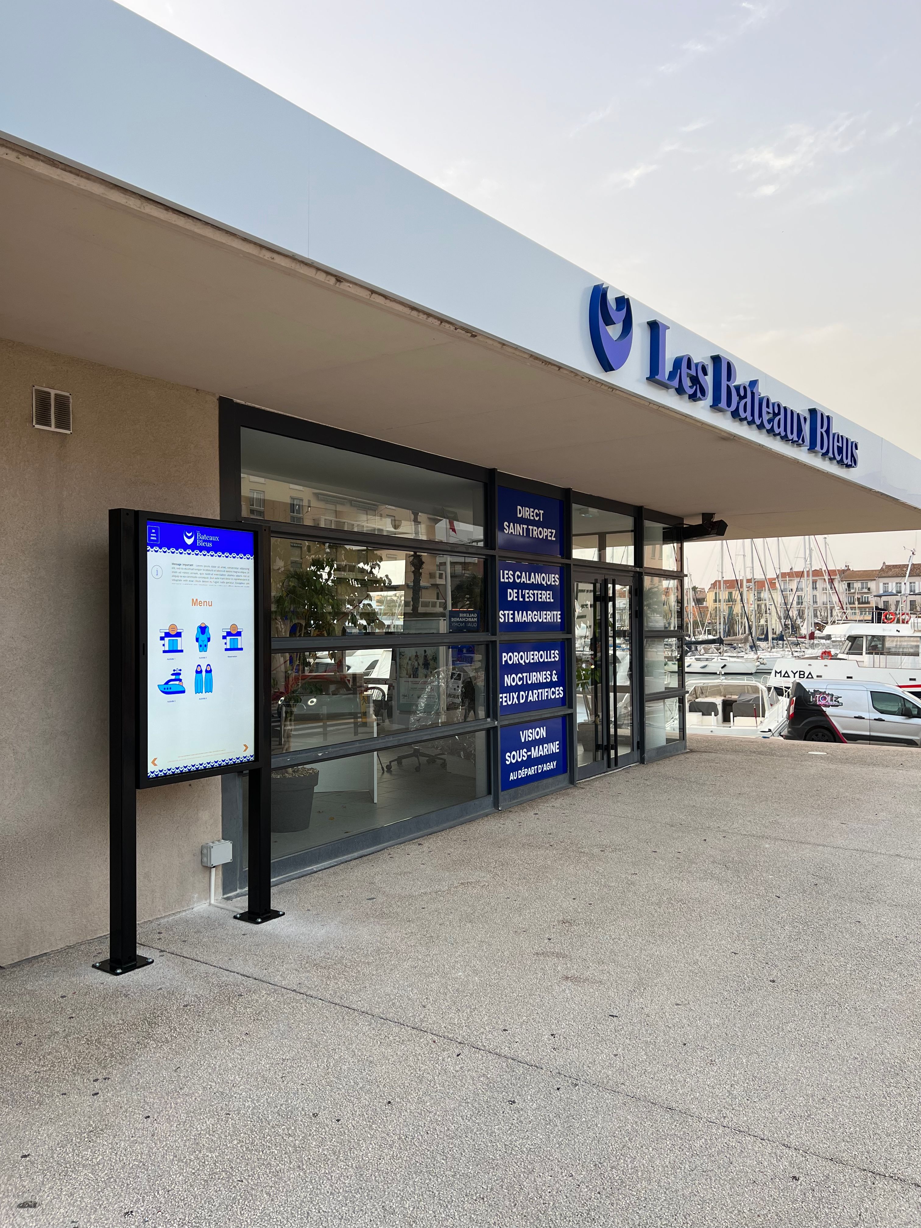 The Les Bateaux Bleus storefront in the old port of Saint-Raphaël, with an order terminal at the entrance