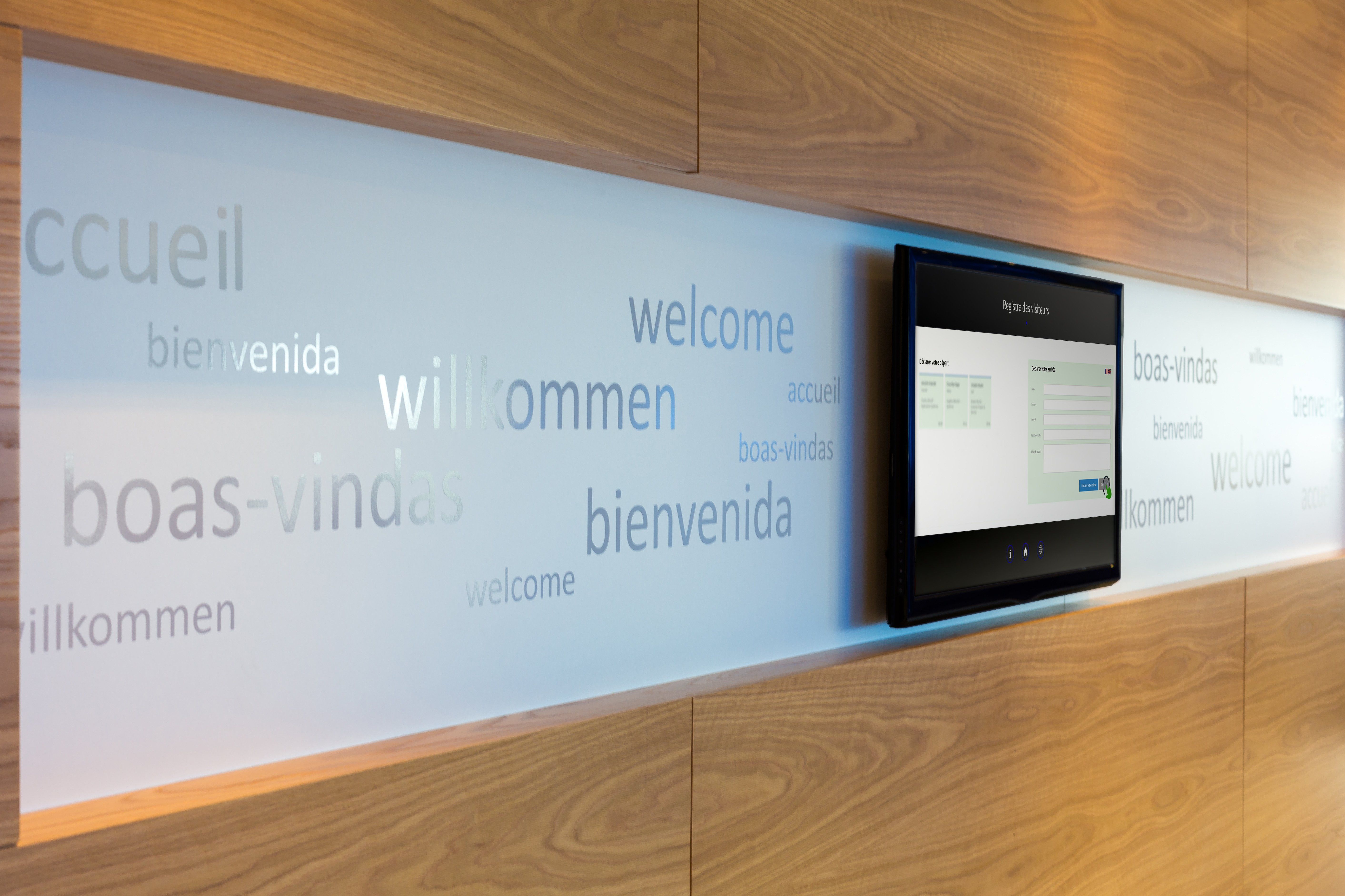 A wall-mounted tablet used as a visitor register