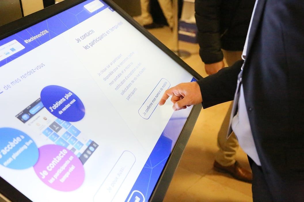 Visitor browsing the Techinnov programme on a touch table