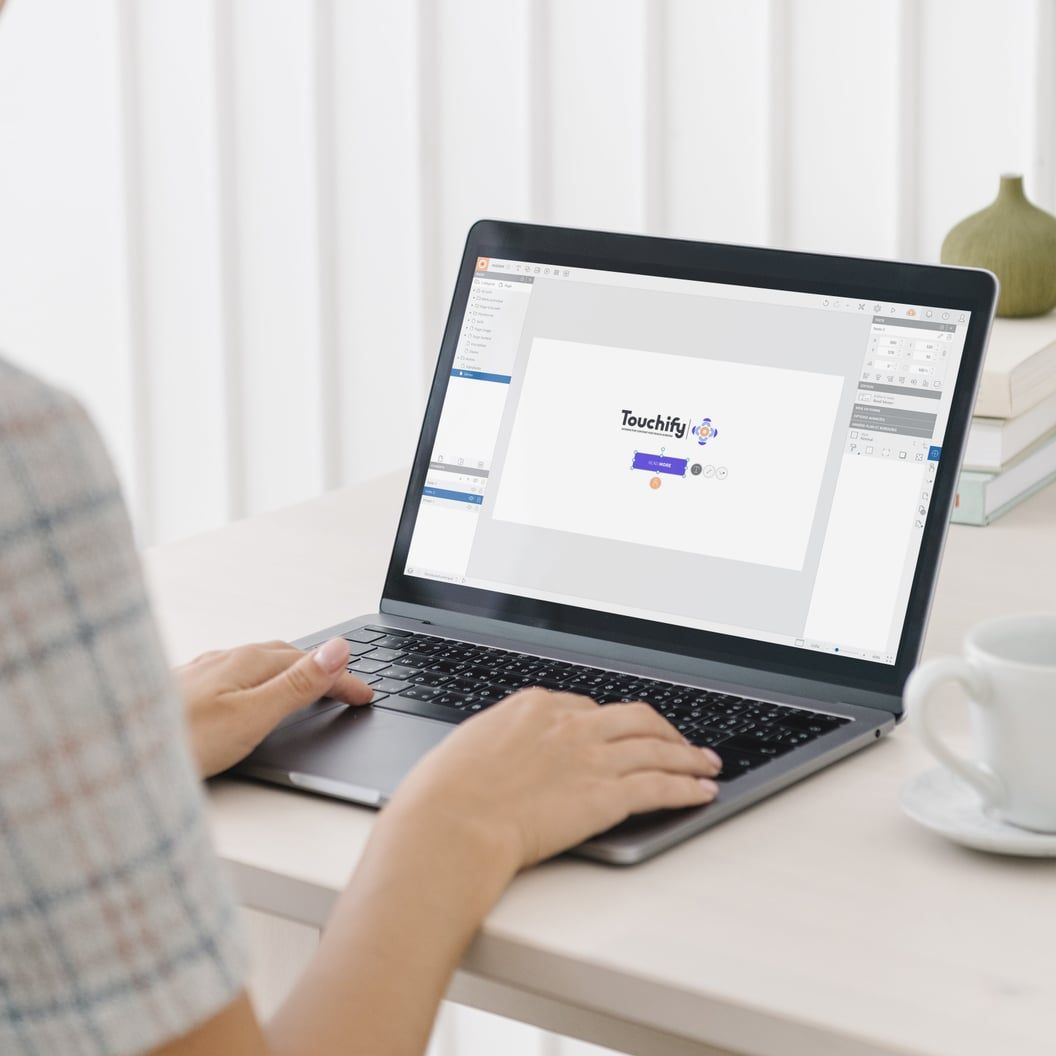 The Touchify Studio editor open on a laptop