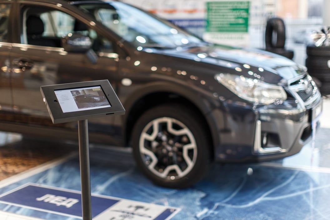 A car on display in a dealership showroom