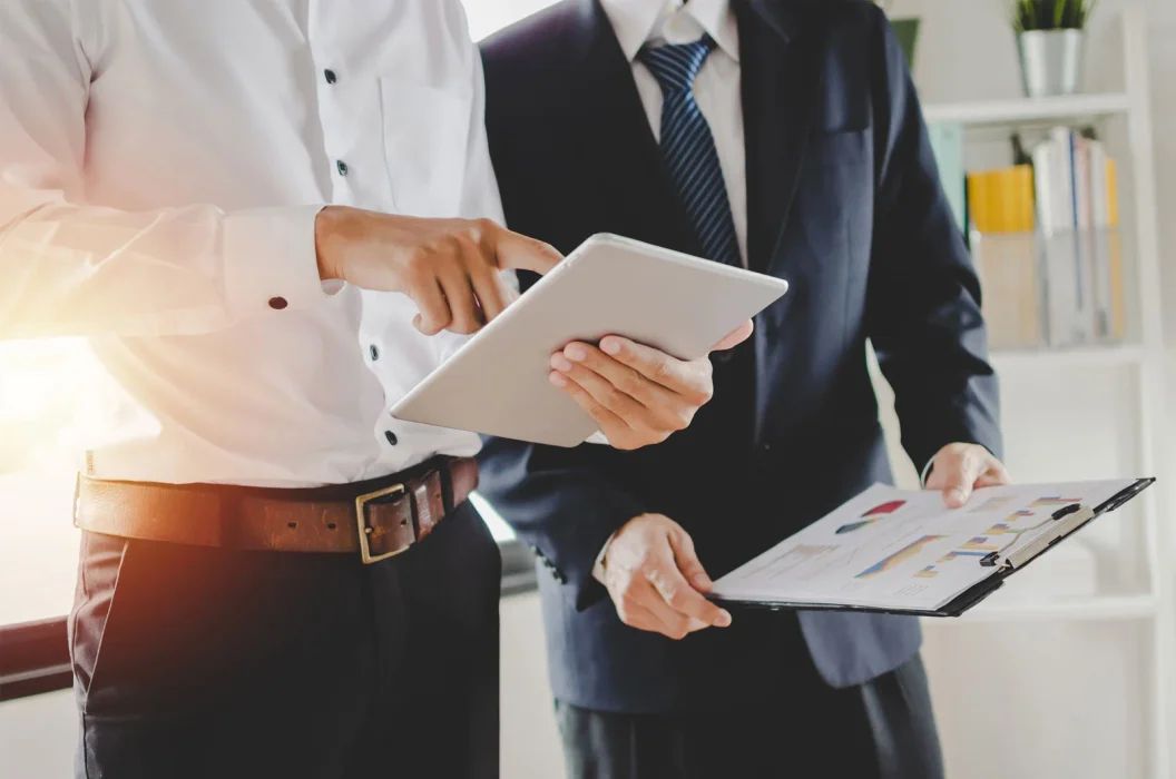 Salesperson presenting an offer on a touch tablet